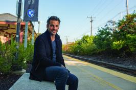 Jim Curtis poses for portrait photo on a bench on the UNH Durham campus.