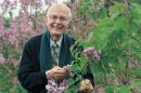 UNH emeritus professor of plant biology Owen Rogers among lilacs