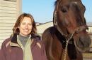 UNH alumna Susan J. Bruns ’78 ’95G with a horse