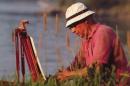 UNH alumnus Arthur Richard DiMambro ’51 painting outdoors