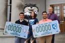 UNH students Jose Calvo of Goffstown, Christian Merheb of Derry, Andrea Plourde of Pembroke and Brennan Pouliot of Goffstown, along with Gnarlz, show off the new UNH license plate decal options on the steps of the State House in Concord